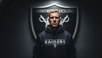 mike vrabel in a black raiders hoodie - Image generated by AI for representational purposes.
